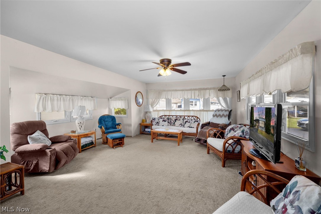 1623 Northeast Catawba Road, Unit 160 Port Clinton, OH 43452 - Photo 6 of 28 Living room featuring light colored carpet and a ceiling fan