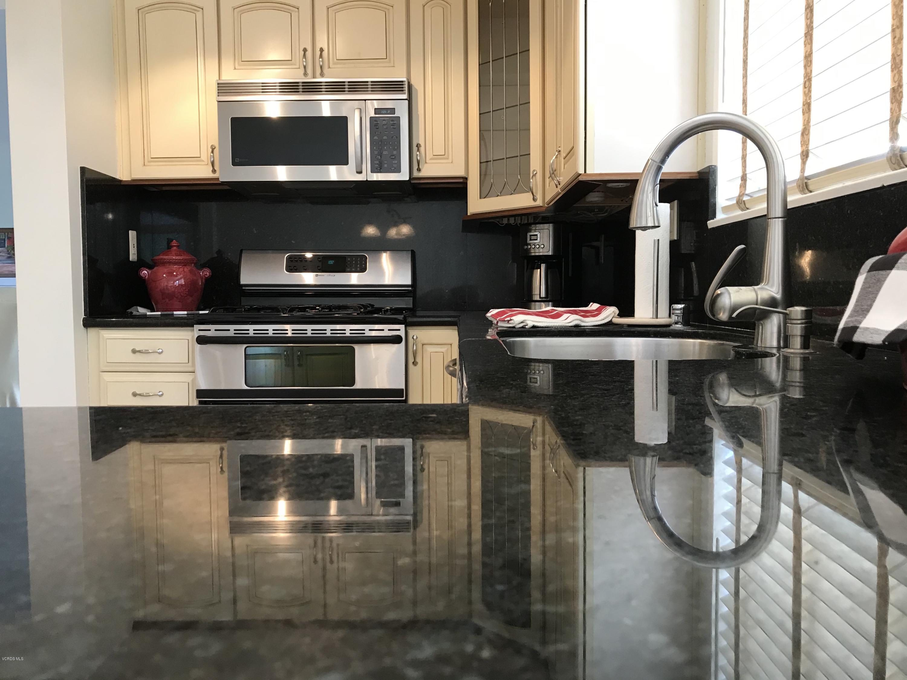 971 Thistlegate Road Oak Park, CA 91377 - Photo 12 of 33 a kitchen with stainless steel appliances granite countertop a stove and a microwave