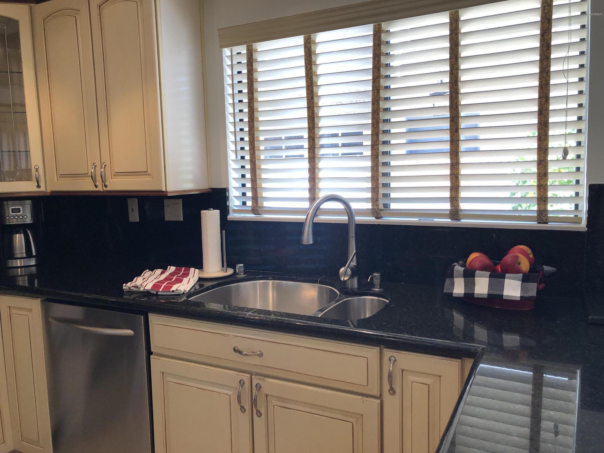 971 Thistlegate Road Oak Park, CA 91377 - Photo 14 of 33 a kitchen with granite countertop a sink window and cabinets