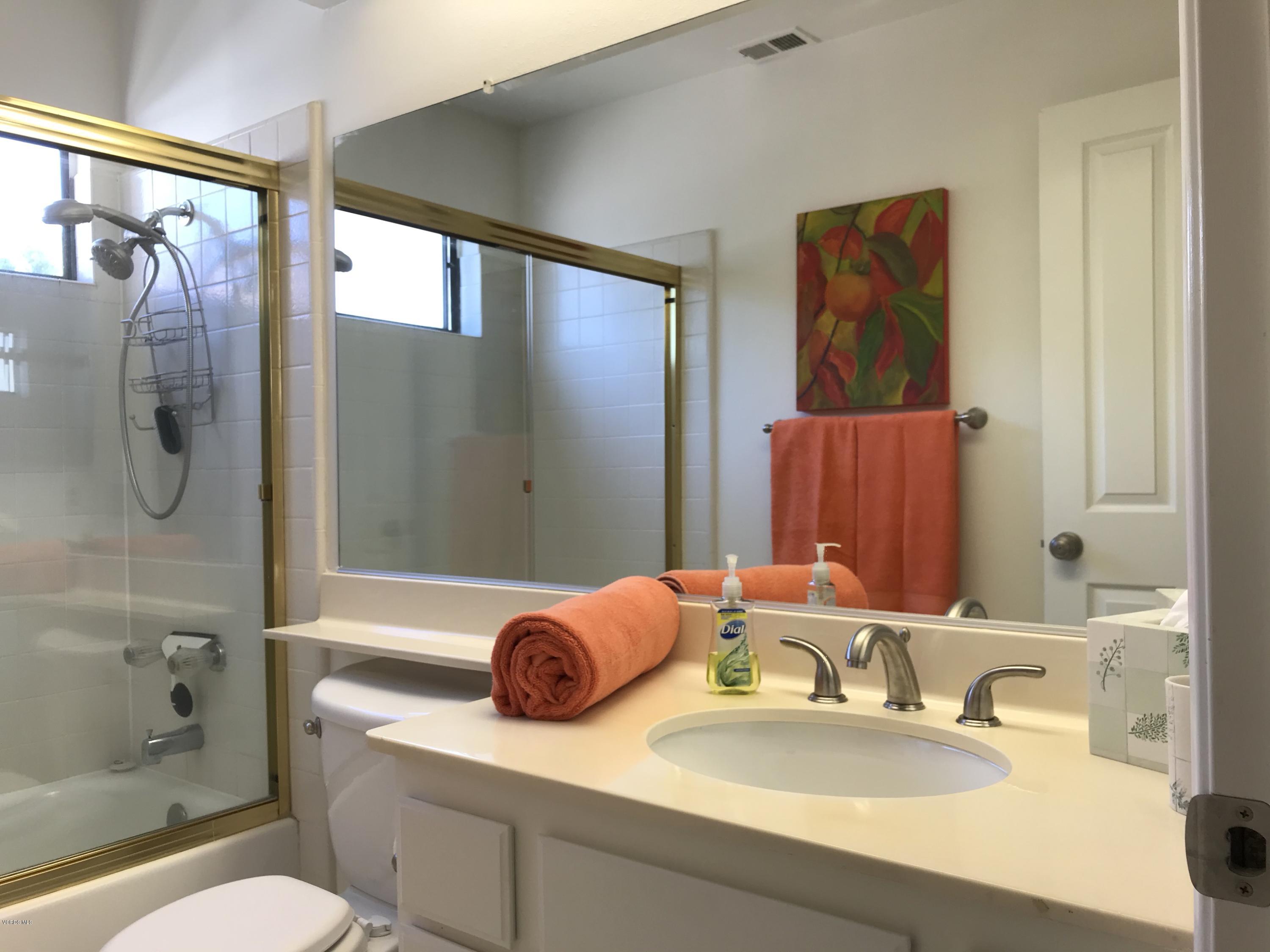 971 Thistlegate Road Oak Park, CA 91377 - Photo 19 of 33 a bathroom with a granite countertop sink mirror vanity and toilet