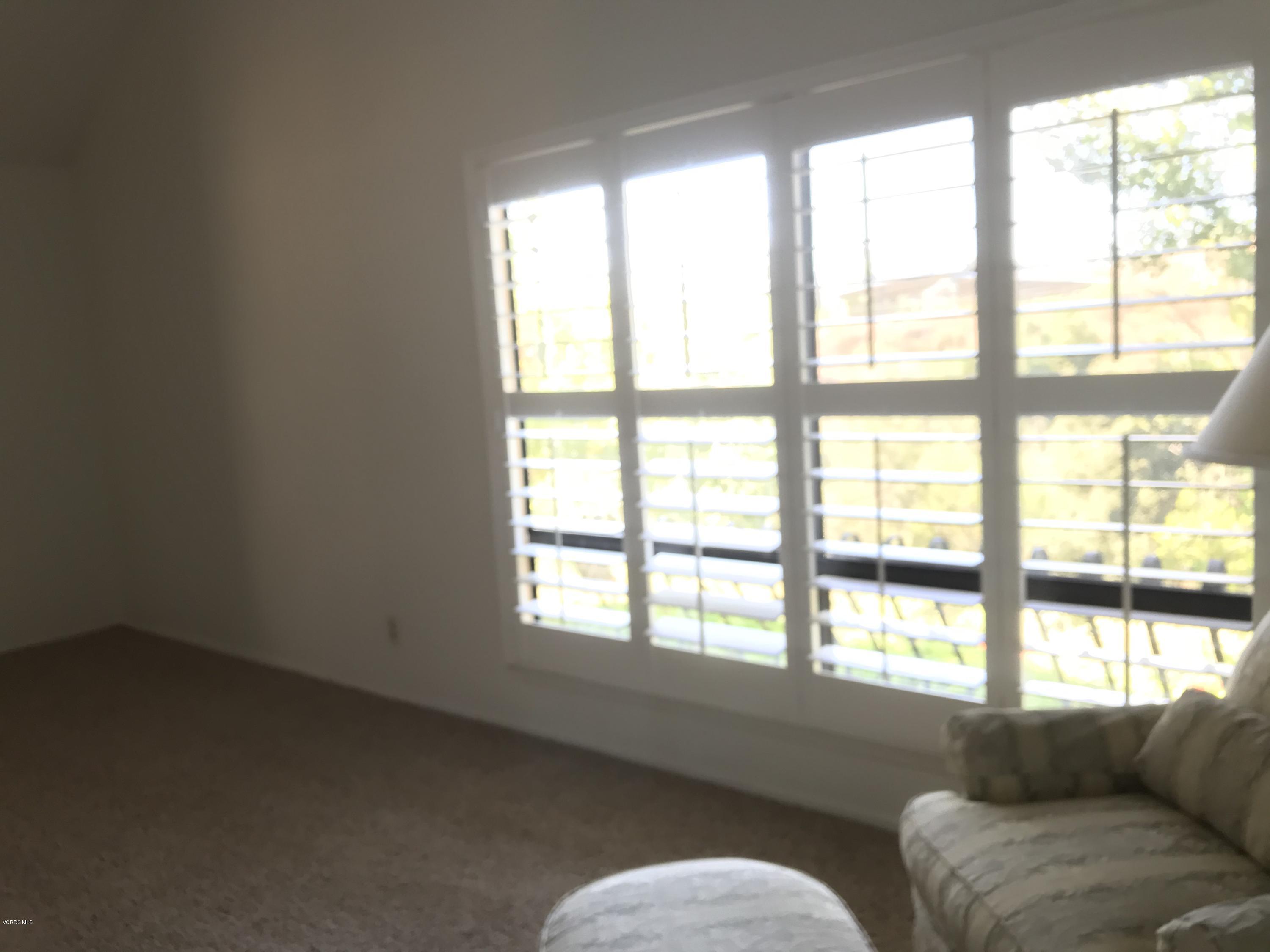 971 Thistlegate Road Oak Park, CA 91377 - Photo 23 of 33 a living room with furniture and a large window