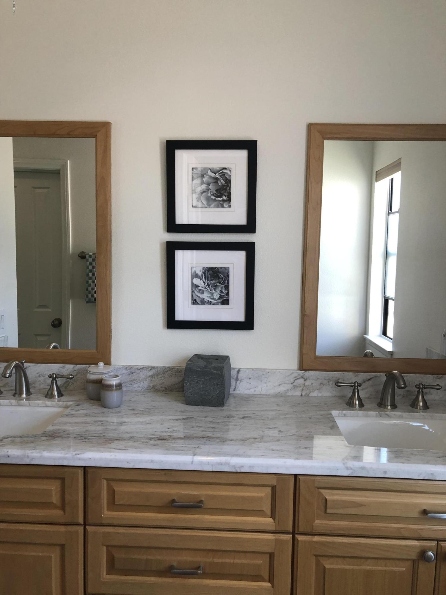 971 Thistlegate Road Oak Park, CA 91377 - Photo 26 of 33 a bathroom with double vanity sinks granite and a mirror