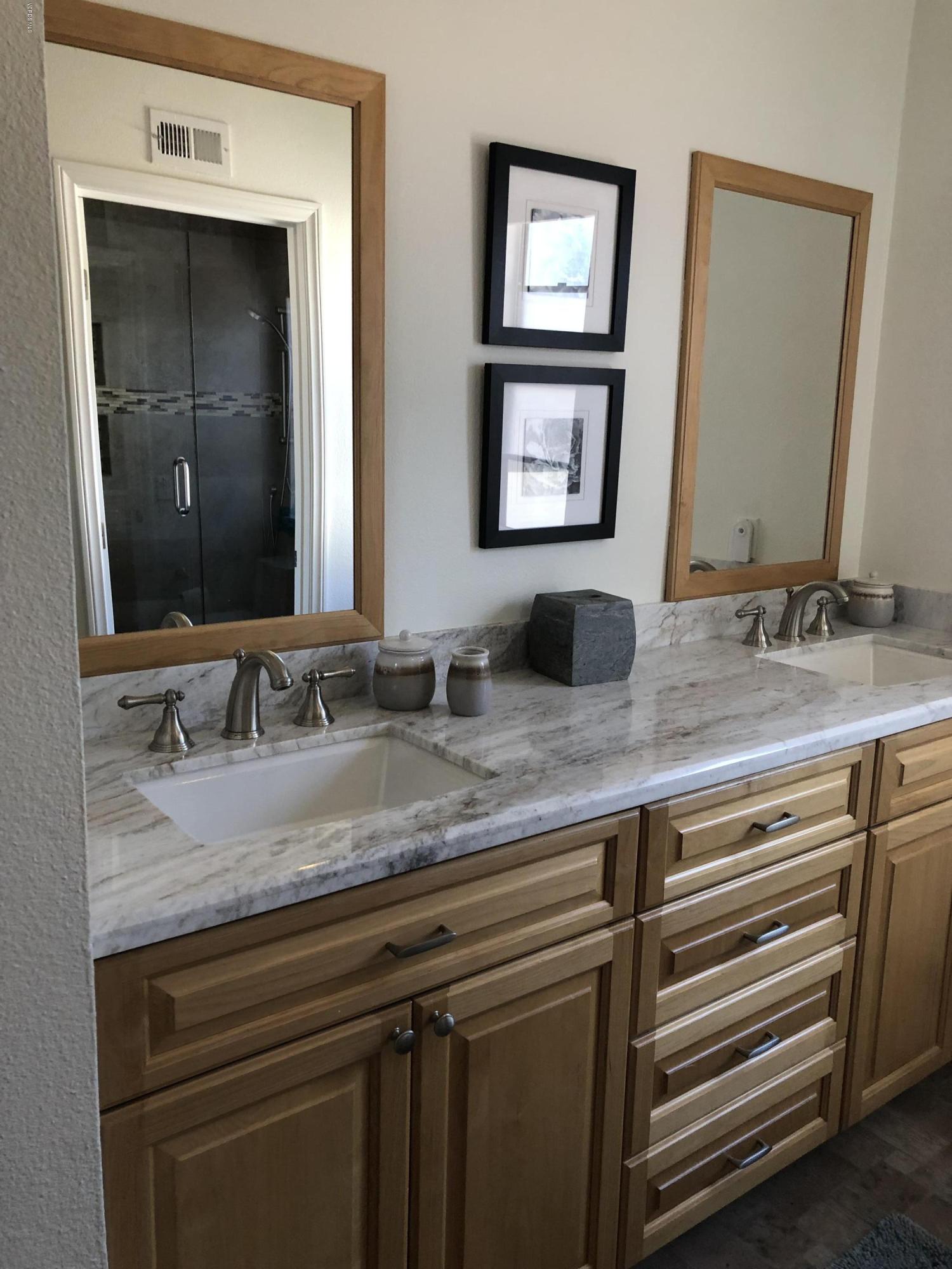 971 Thistlegate Road Oak Park, CA 91377 - Photo 27 of 33 a bathroom with a sink and a mirror