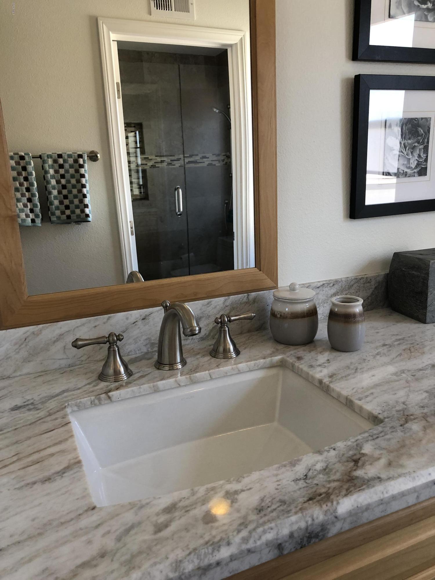 971 Thistlegate Road Oak Park, CA 91377 - Photo 28 of 33 a bathroom with a sink and a mirror