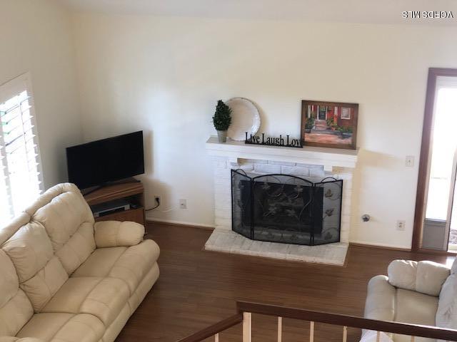 971 Thistlegate Road Oak Park, CA 91377 - Photo 5 of 33 a living room with furniture and a flat screen tv