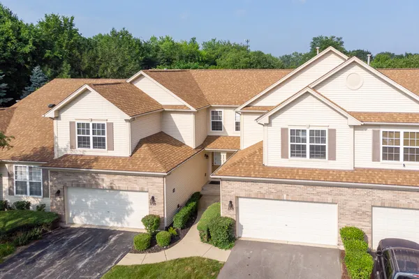 a aerial view of a house with a yard