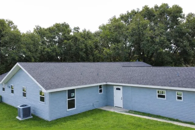 a aerial view of a house with a yard