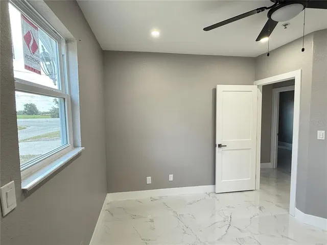 an empty room with an entrance to other room