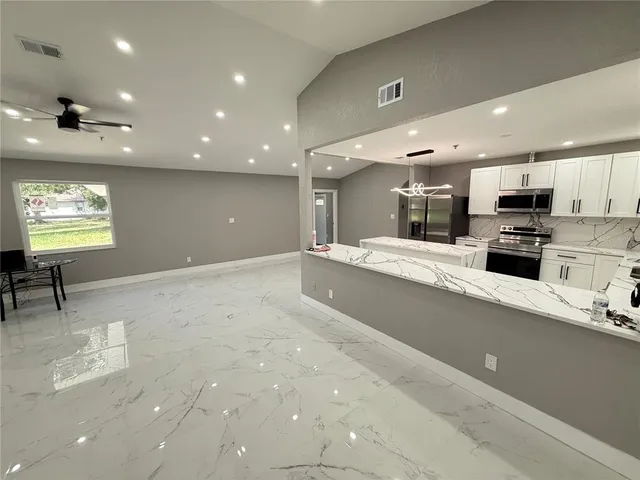 a kitchen with a refrigerator a sink and a stove