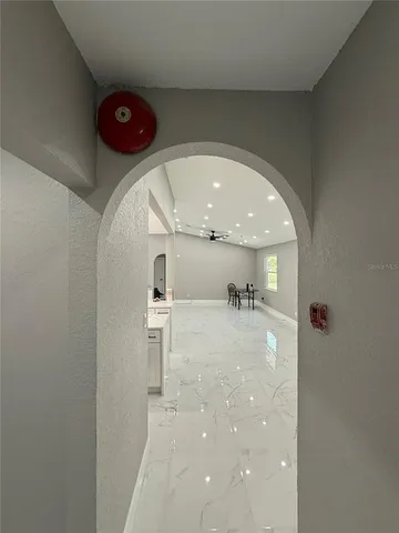 a large kitchen with stainless steel appliances granite countertop a large counter top a stove and a sink