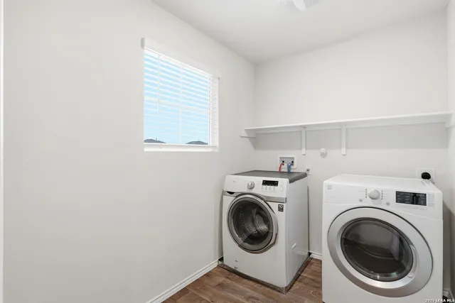 a view of a storage & utility room with dryer and washer