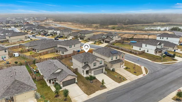 an aerial view of residential houses with outdoor space