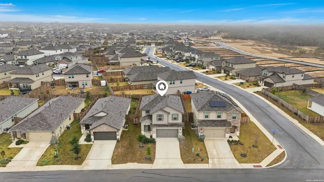 an aerial view of residential houses with outdoor space