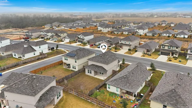an aerial view of residential houses with outdoor space