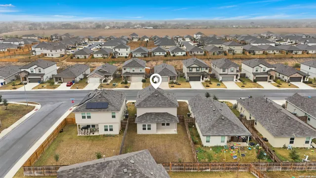 an aerial view of residential houses with outdoor space