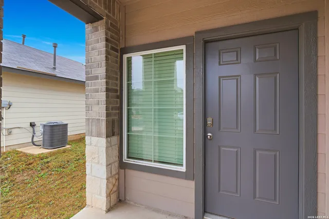 a view of a door and brick walls