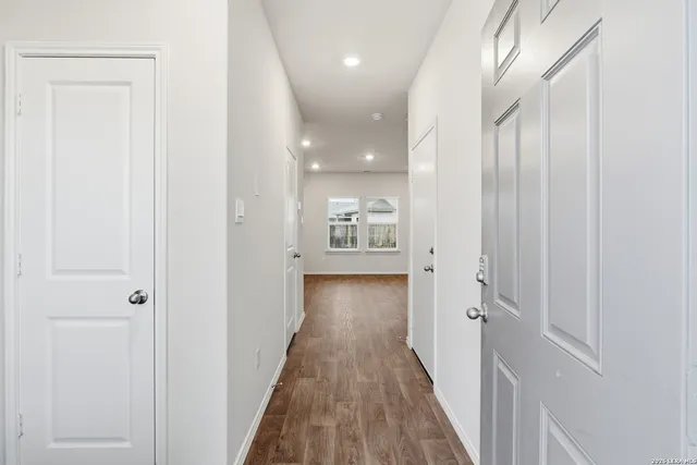 a view of hallway with wooden floor