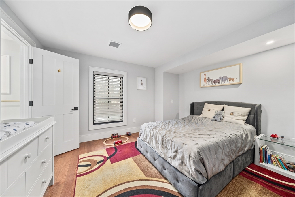 300 Elliot Street, Unit 2 Newton, MA 02464 - Photo 24 of 42 a bedroom with bed and a window