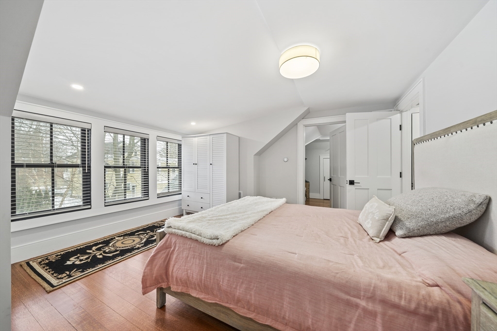 300 Elliot Street, Unit 2 Newton, MA 02464 - Photo 27 of 42 a bedroom with a bed and a window