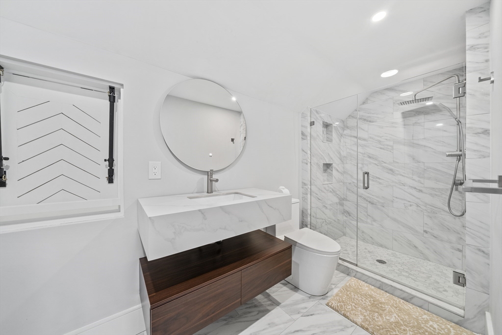 300 Elliot Street, Unit 2 Newton, MA 02464 - Photo 28 of 42 a bathroom with a sink a toilet and shower