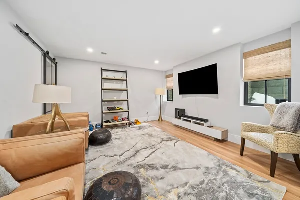 a bedroom with furniture and a large window