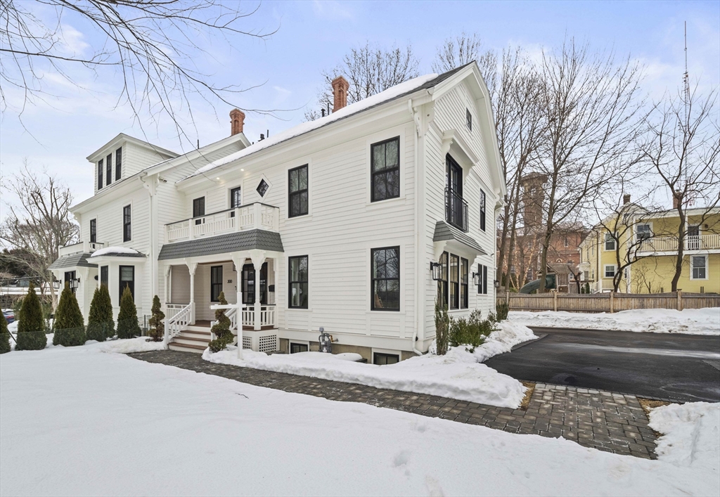 300 Elliot Street, Unit 2 Newton, MA 02464 - Photo 36 of 42 a view of a white house with a large tree
