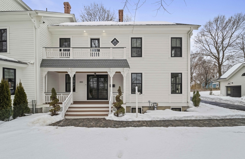 300 Elliot Street, Unit 2 Newton, MA 02464 - Photo 42 of 42 a front view of a house with a yard