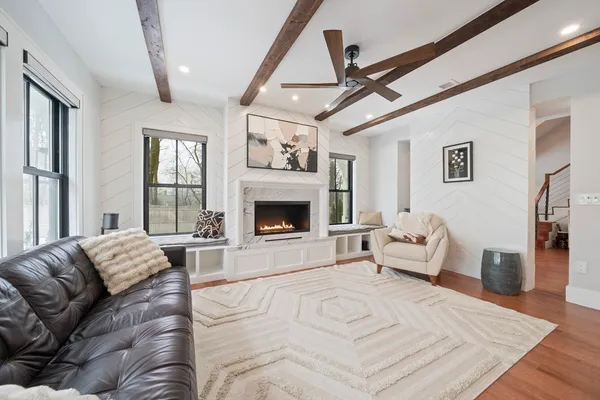 a spacious bedroom with a large bed couch and a window
