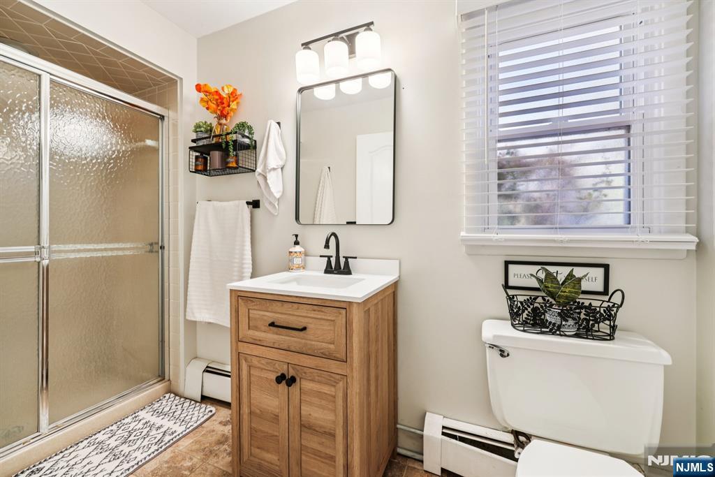 234 Spring Valley Road Park Ridge, NJ 07656 - Photo 16 of 40 a bathroom with a sink a toilet and shower