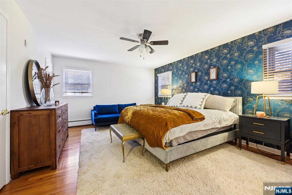 234 Spring Valley Road Park Ridge, NJ 07656 - Photo 18 of 40 a spacious bedroom with a bed and wooden floor