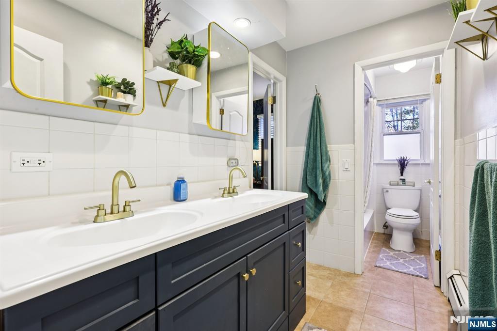 234 Spring Valley Road Park Ridge, NJ 07656 - Photo 19 of 40 a bathroom with a sink a toilet and mirror
