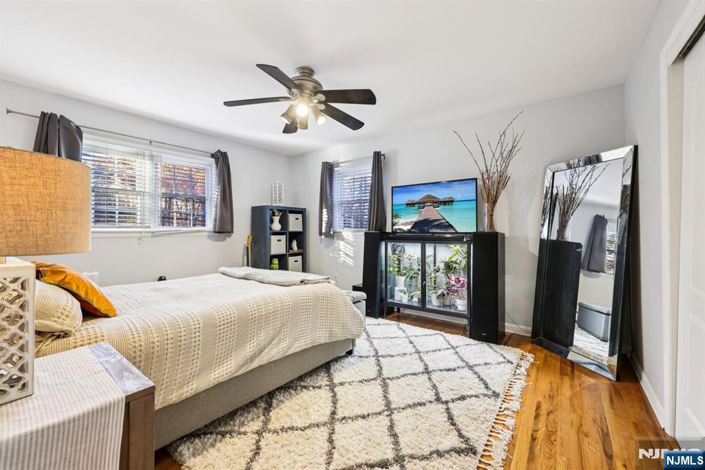 234 Spring Valley Road Park Ridge, NJ 07656 - Photo 21 of 40 a bedroom with a large bed and a chandelier