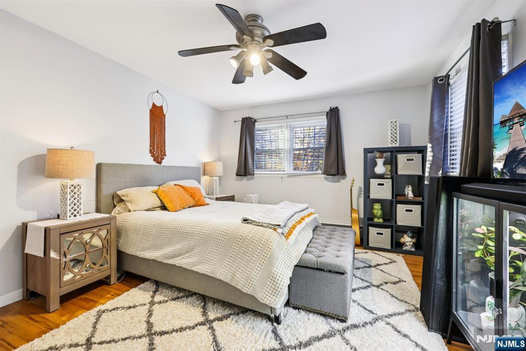 234 Spring Valley Road Park Ridge, NJ 07656 - Photo 22 of 40 a bedroom with a bed and wooden floor