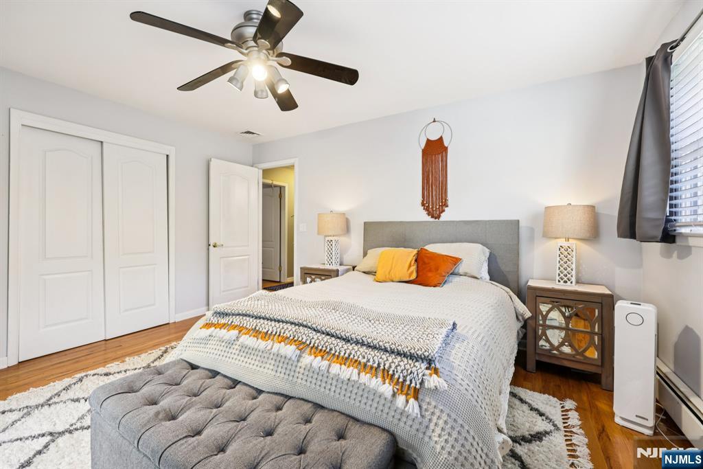 234 Spring Valley Road Park Ridge, NJ 07656 - Photo 23 of 40 a bedroom with a bed and a chandelier