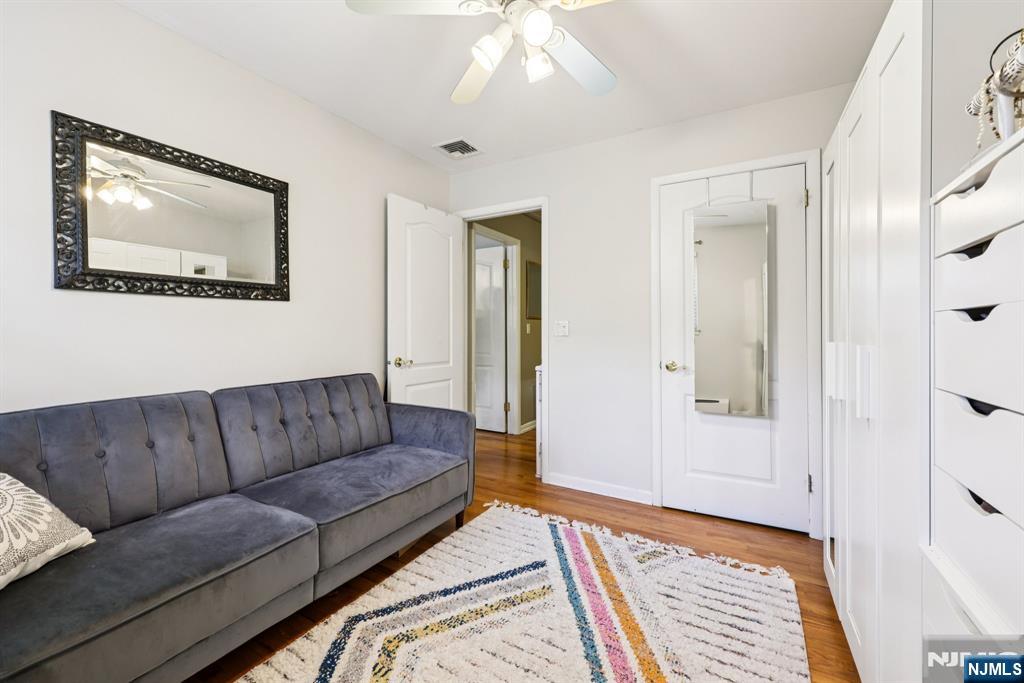 234 Spring Valley Road Park Ridge, NJ 07656 - Photo 25 of 40 a living room with furniture and a baby crib