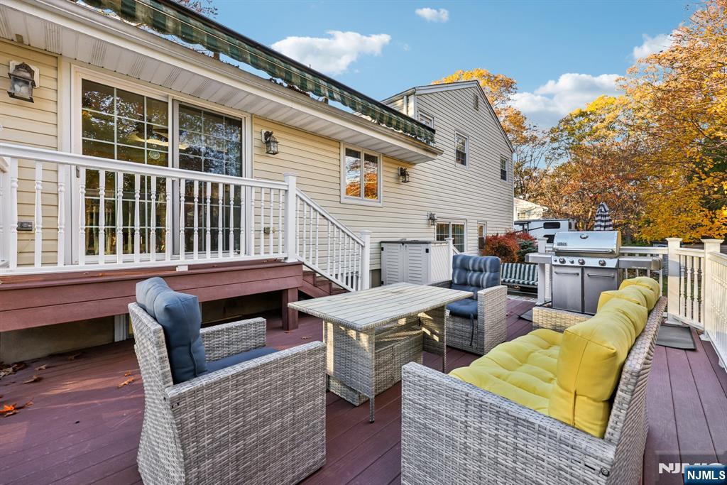 234 Spring Valley Road Park Ridge, NJ 07656 - Photo 30 of 40 a backyard of a house with barbeque oven table and chairs