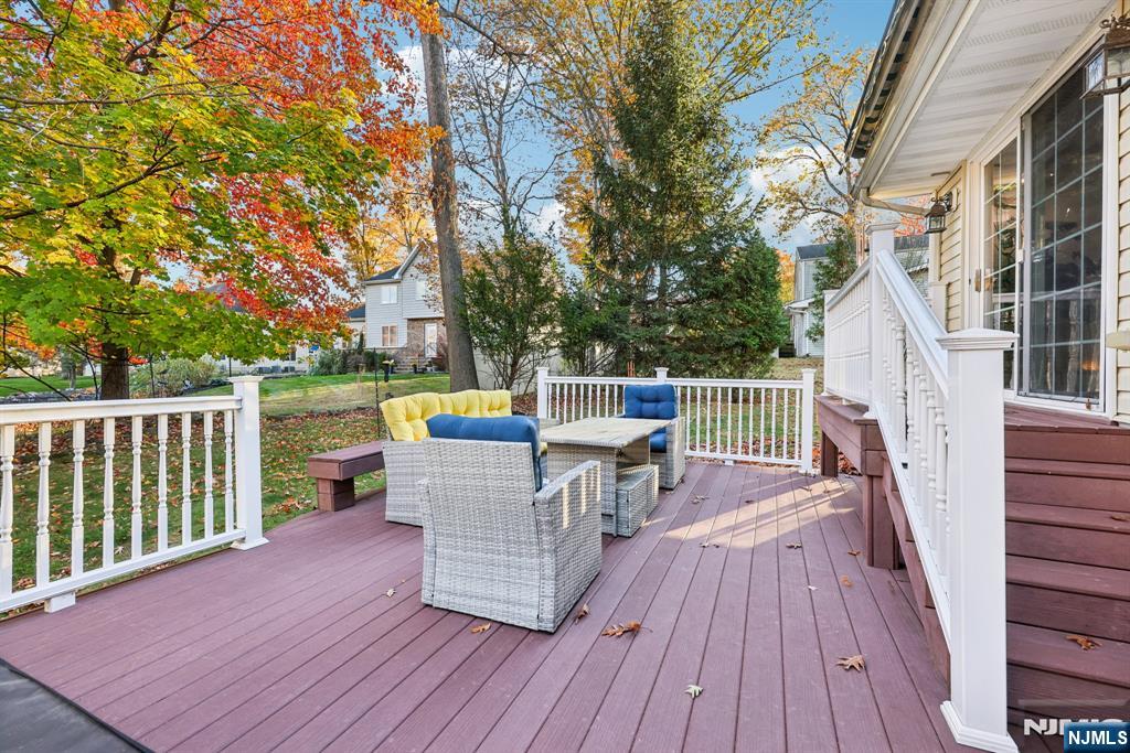 234 Spring Valley Road Park Ridge, NJ 07656 - Photo 31 of 40 a view of a deck with table and chairs and wooden floor