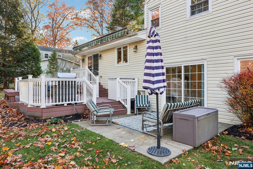 234 Spring Valley Road Park Ridge, NJ 07656 - Photo 32 of 40 a view of a chair and table in backyard of the house