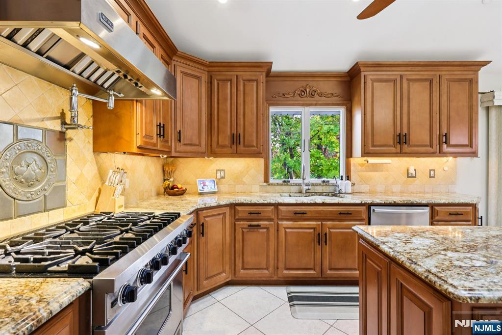 234 Spring Valley Road Park Ridge, NJ 07656 - Photo 9 of 40 a kitchen with a stove sink and cabinets