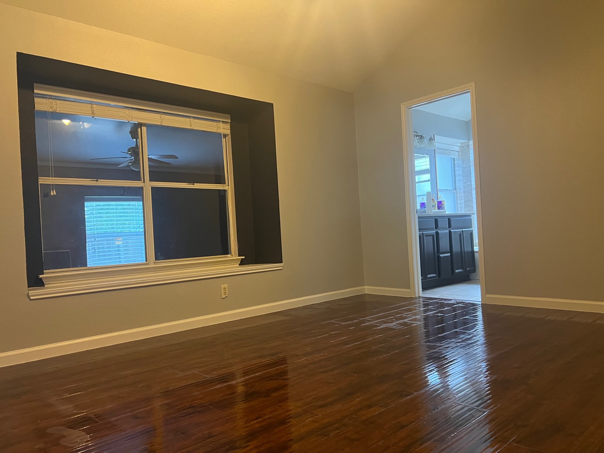 5611 Meadow Crest Austin, TX 78744 - Photo 17 of 29 an empty room with wooden floor and windows