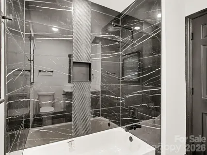 a bathroom with a shower and a mirror