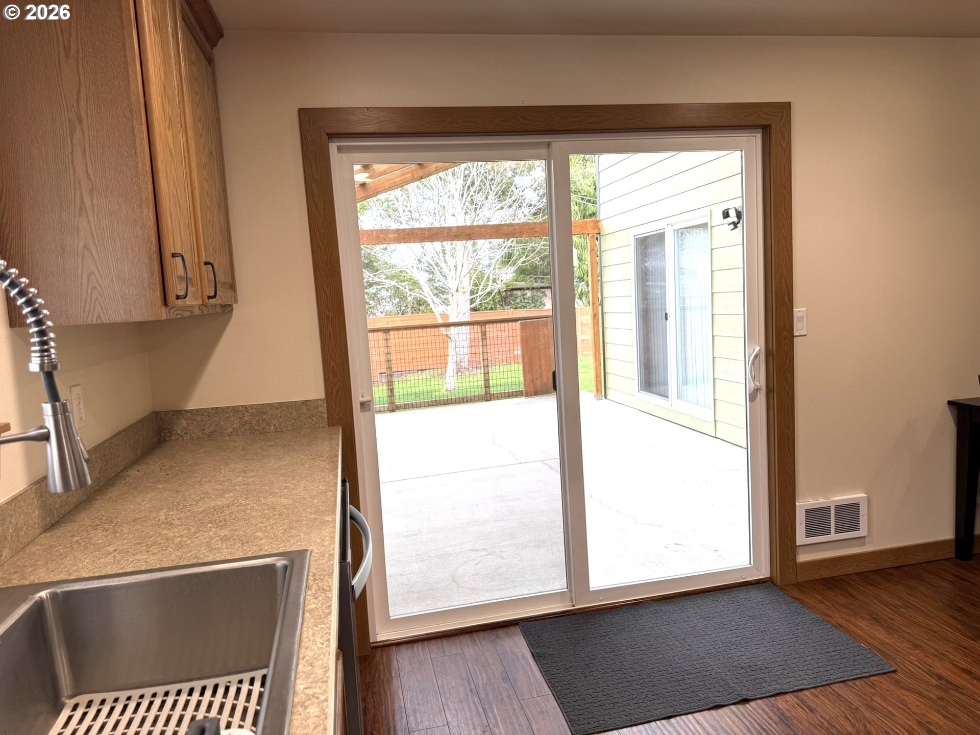 1651 29th Street Florence, OR 97439 - Photo 13 of 31 a view of an empty room with wooden floor and a window