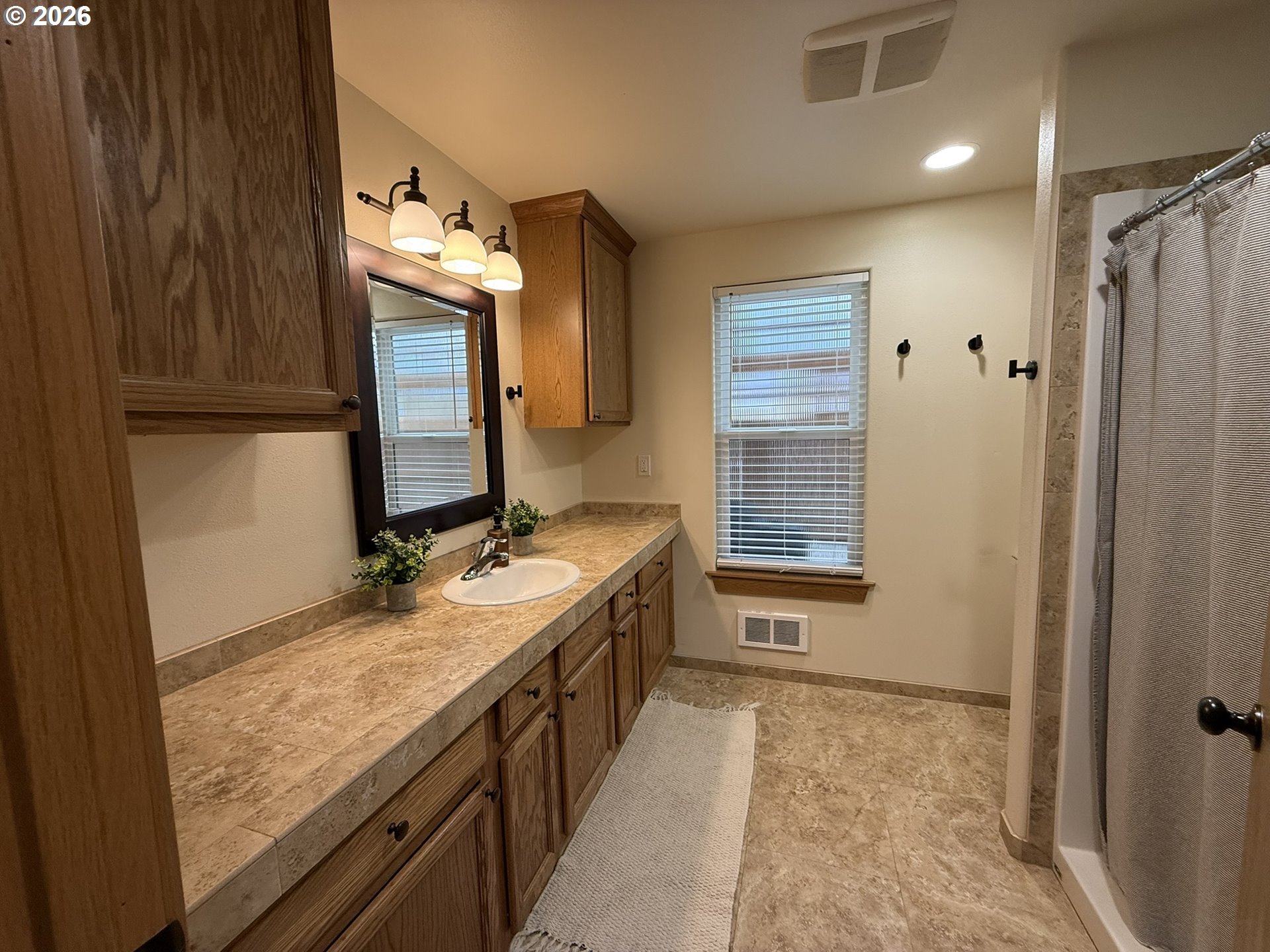 1651 29th Street Florence, OR 97439 - Photo 23 of 31 a bathroom with a granite countertop sink and a mirror