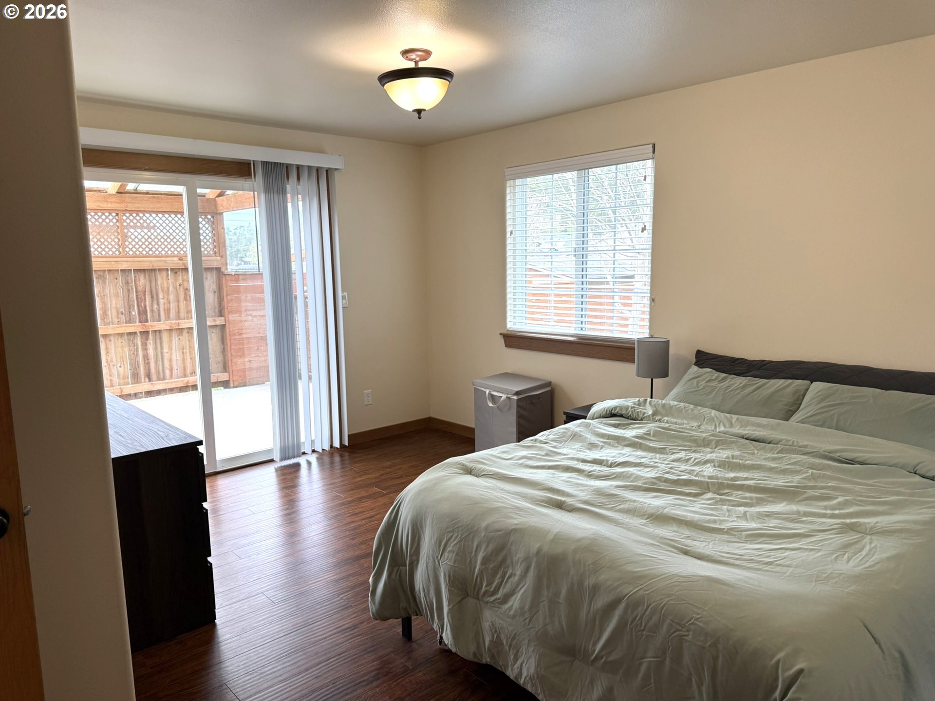 1651 29th Street Florence, OR 97439 - Photo 24 of 31 a spacious bedroom with a bed and a large window