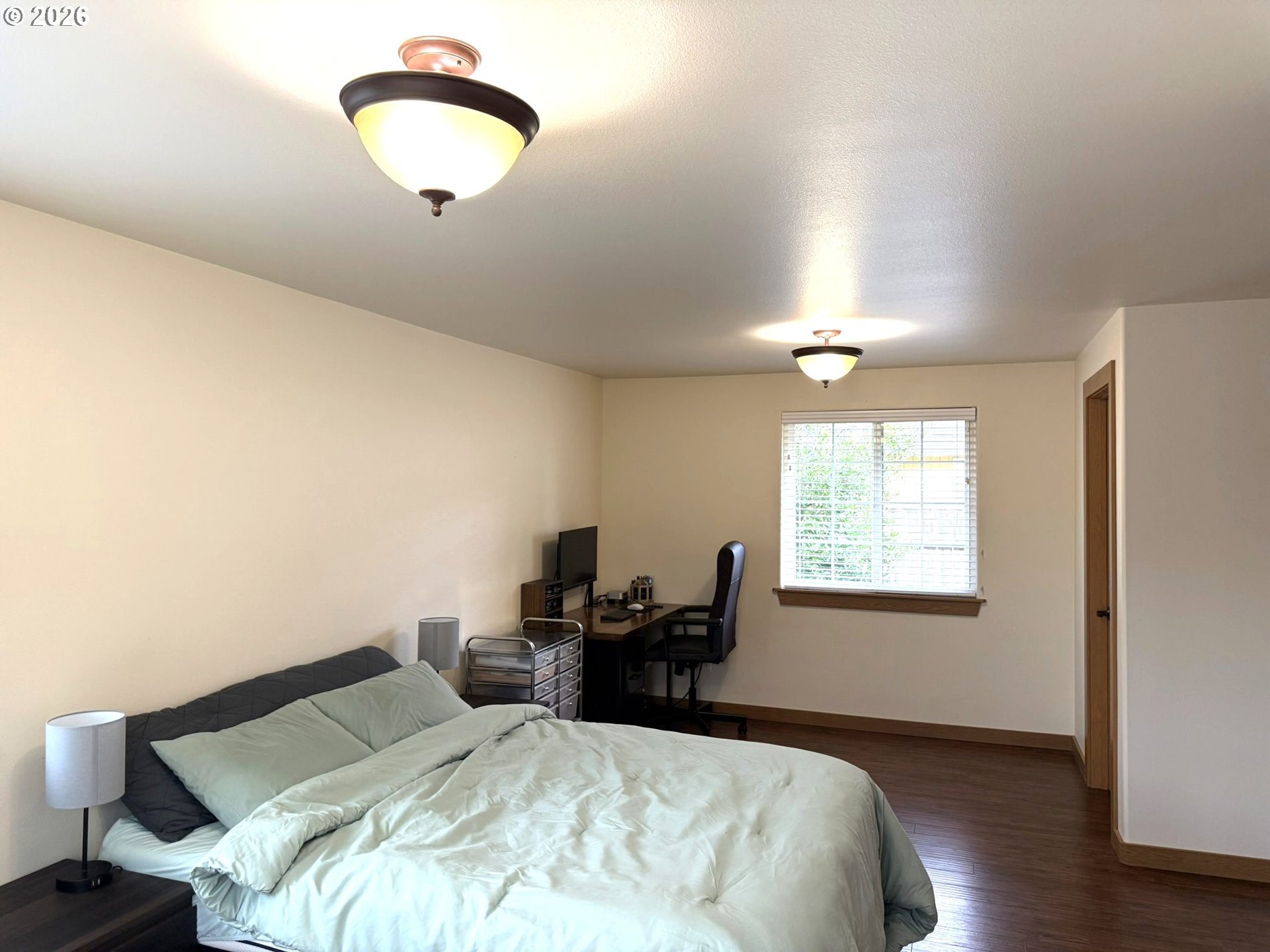 1651 29th Street Florence, OR 97439 - Photo 26 of 31 a bed room with a bed and a chandelier