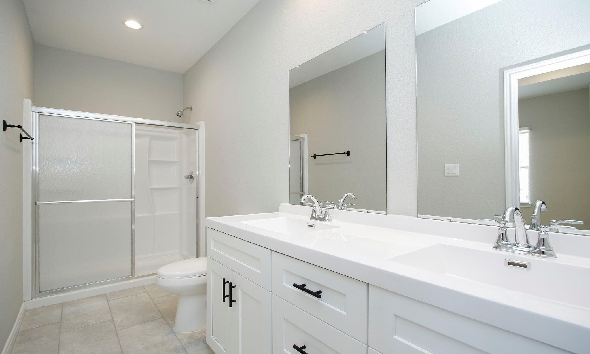 14010 Longstreet Road Willis, TX 77318 - Photo 5 of 22 Double sinks in the primary bathroom