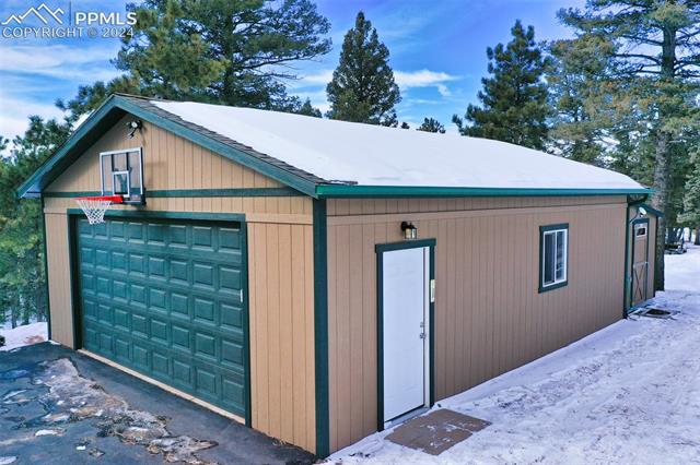 T1-11 wood siding, shingle roof, 8x12 garage door built by Tuff shed. 