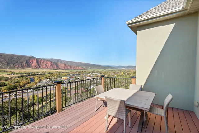 a view of a balcony with wooden floor and city view