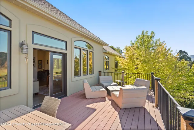a balcony with furniture and wooden floor