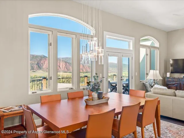 a view of a dining room with furniture and a large window